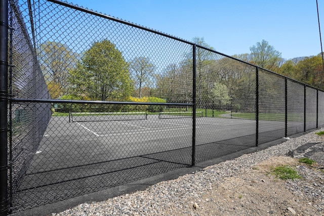 view of sport court featuring fence