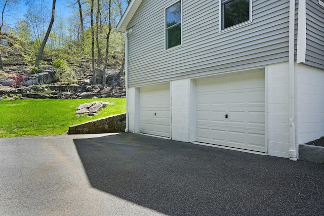 garage with aphalt driveway