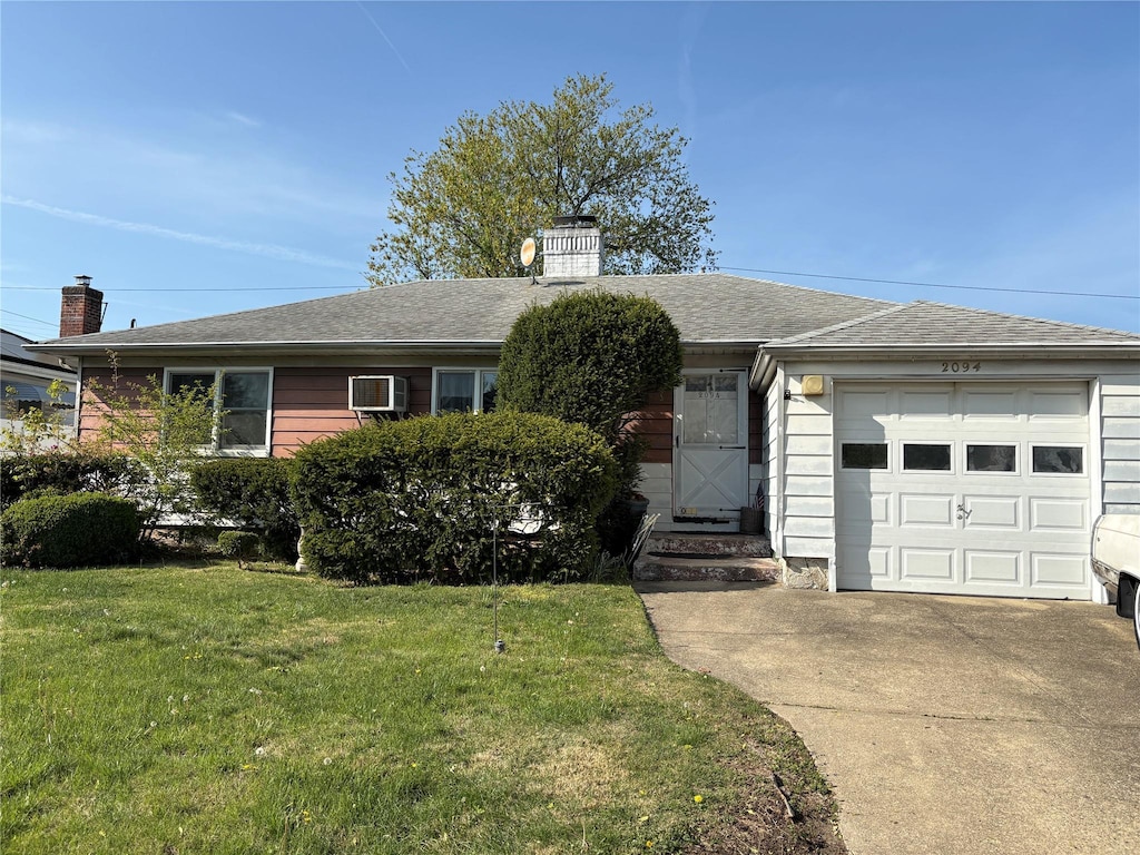 single story home featuring a garage, a front yard, roof with shingles, a chimney, and concrete driveway