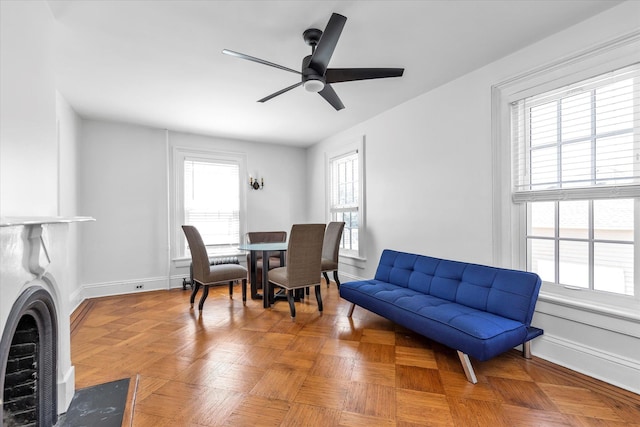 interior space with baseboards and ceiling fan