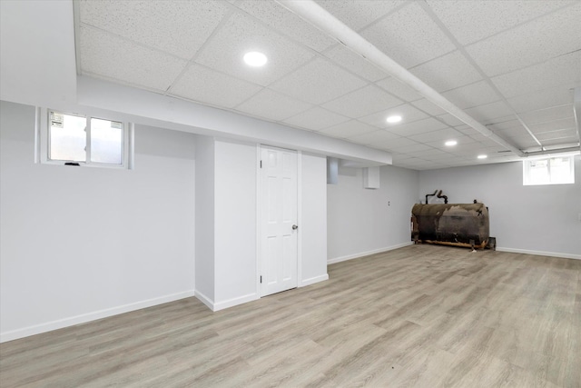 basement with recessed lighting, light wood finished floors, and heating fuel