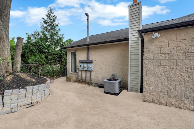 362 Mooney Pond Rd, Farmingville, NY 11738 - view of side of property with a patio area, central air condition unit, fence, a chimney, and roof with shingles