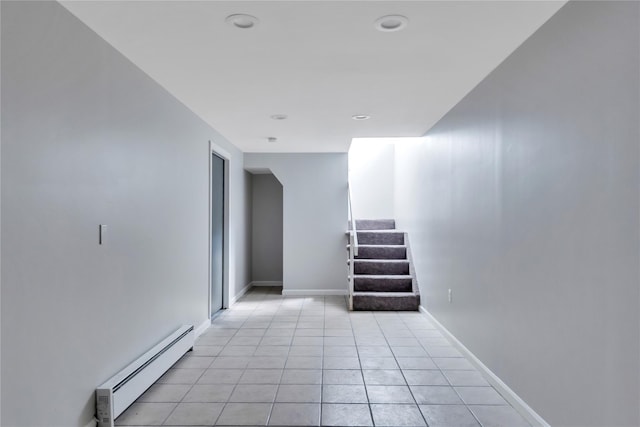 362 Mooney Pond Rd, Farmingville, NY 11738 - hall with baseboard heating, stairs, light tile patterned floors, and baseboards