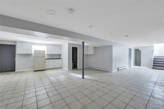 362 Mooney Pond Rd, Farmingville, NY 11738 - finished basement featuring freestanding refrigerator, a baseboard heating unit, a baseboard radiator, stairs, and light tile patterned flooring