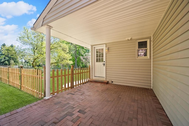 view of patio with covered porch and fence