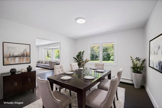 dining area featuring baseboards, wood finished floors, and baseboard heating