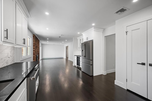 kitchen with visible vents, appliances with stainless steel finishes, a baseboard radiator, recessed lighting, and dark wood-type flooring