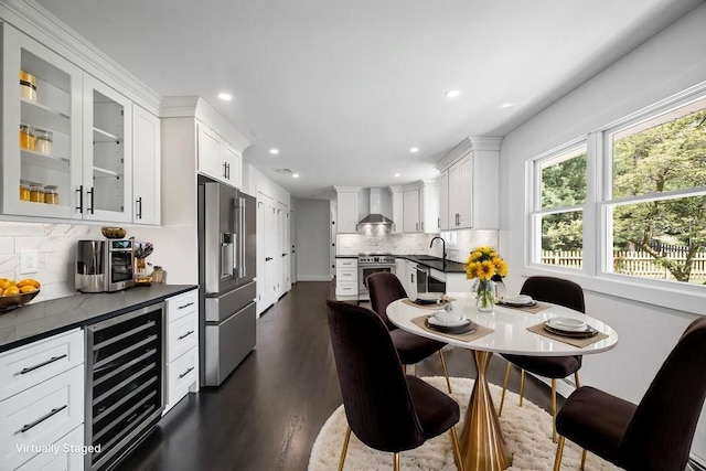 dining room with dark wood-type flooring, recessed lighting, and wine cooler