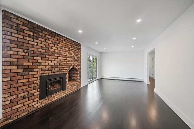 unfurnished living room with baseboard heating, a brick fireplace, wood finished floors, baseboards, and recessed lighting