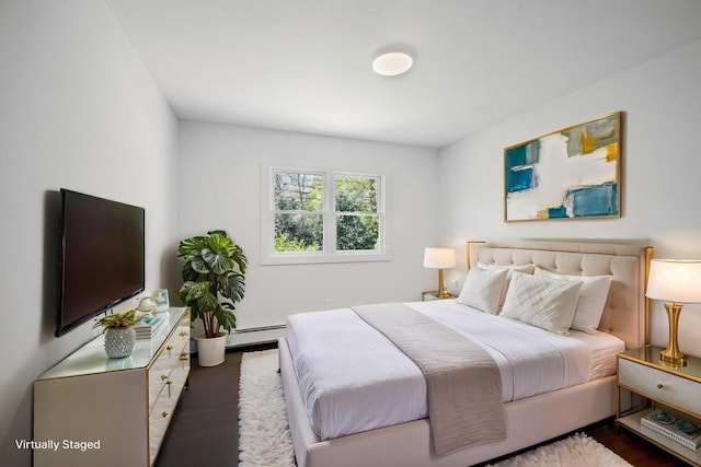 85 Meadow Glen Rd, Fort Salonga, NY 11768 - bedroom featuring a baseboard heating unit and wood finished floors
