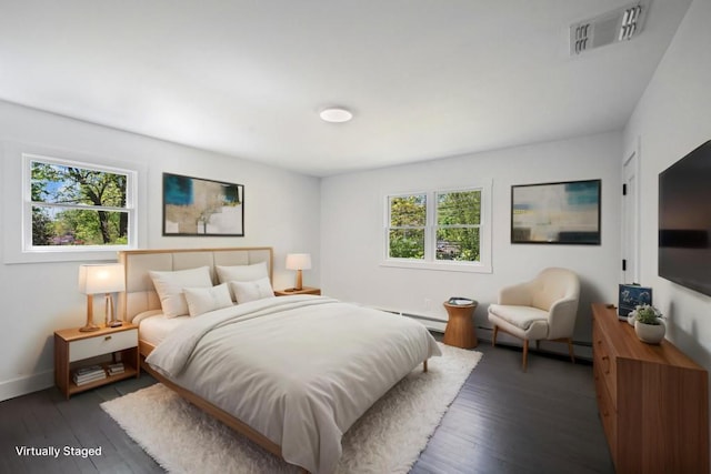 bedroom featuring baseboards, hardwood / wood-style flooring, and visible vents