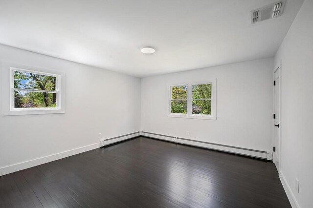 85 Meadow Glen Rd, Fort Salonga, NY 11768 - unfurnished room with a baseboard radiator, baseboard heating, dark wood-style floors, and visible vents