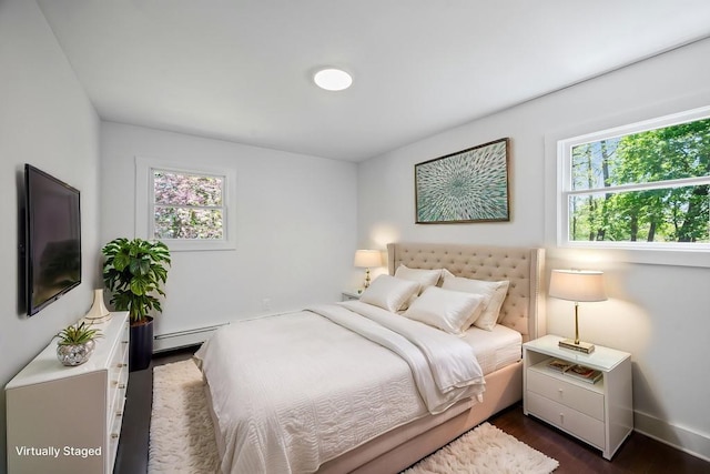 bedroom featuring dark wood-style flooring and baseboards