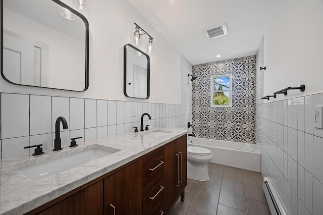 bathroom with baseboard heating, a sink, toilet, tile walls, and visible vents