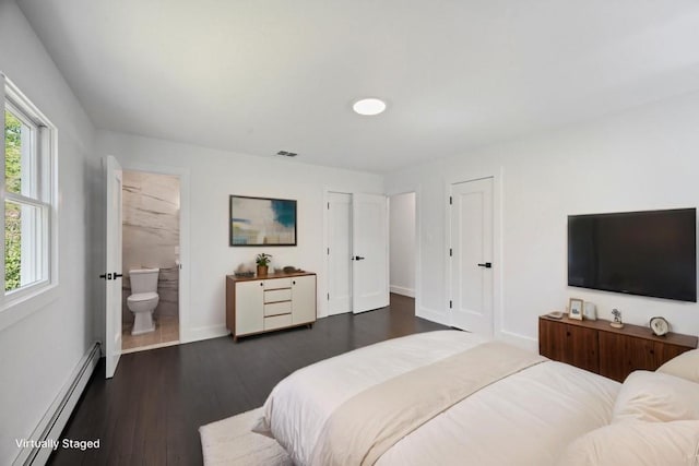 bedroom with visible vents, baseboards, a baseboard radiator, connected bathroom, and dark wood-type flooring