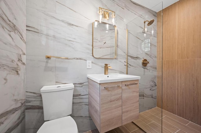 full bath with a walk in shower, toilet, tile walls, and vanity