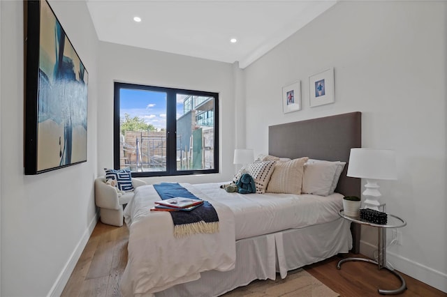 bedroom featuring baseboards, recessed lighting, and wood finished floors