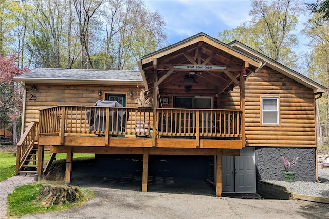 25 E Reindeer Trl, Bethel, NY 12778 - back of property with stairway, a garage, a wooden deck, and aphalt driveway