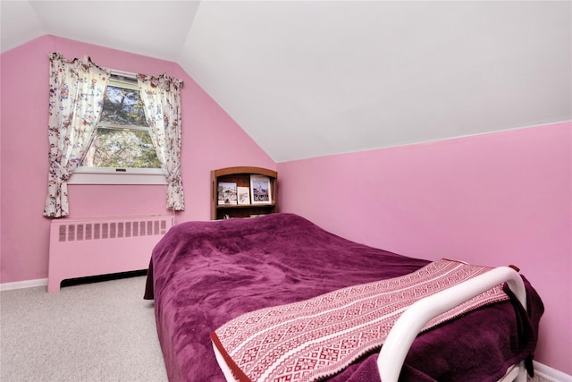 carpeted bedroom with baseboards, radiator heating unit, and lofted ceiling