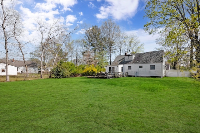 view of yard with fence and a wooden deck