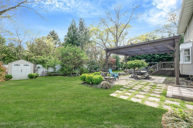 view of yard with a patio, an outdoor structure, and a storage unit