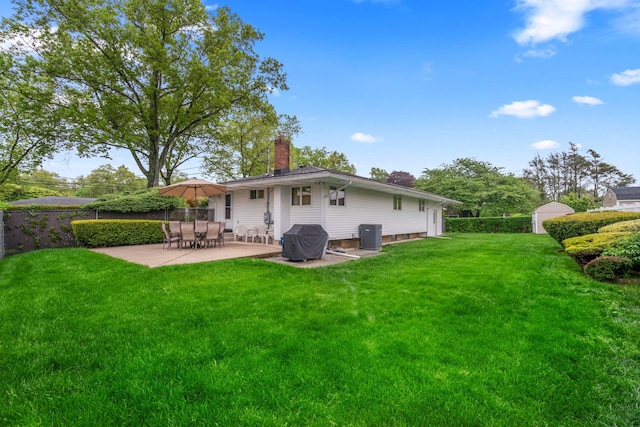 15 Kevin Rd, Commack, NY 11725 - back of property featuring a patio and a chimney