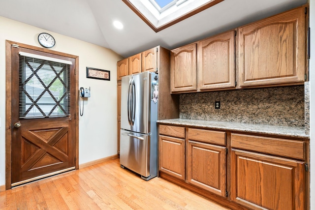 15 Kevin Rd, Commack, NY 11725 - kitchen with freestanding refrigerator, light wood-type flooring, tasteful backsplash, a skylight, and baseboards