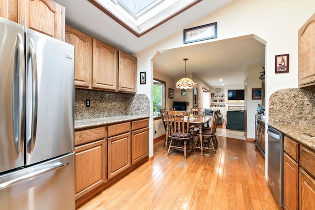 15 Kevin Rd, Commack, NY 11725 - kitchen with stainless steel appliances, open floor plan, light wood finished floors, decorative backsplash, and high vaulted ceiling