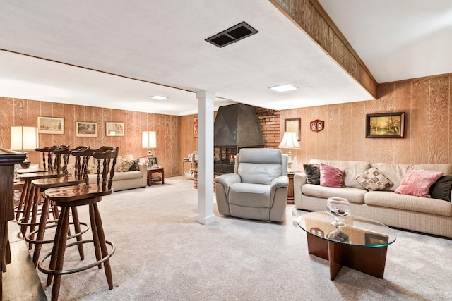 15 Kevin Rd, Commack, NY 11725 - living room with a fireplace, carpet floors, wood walls, and a dry bar