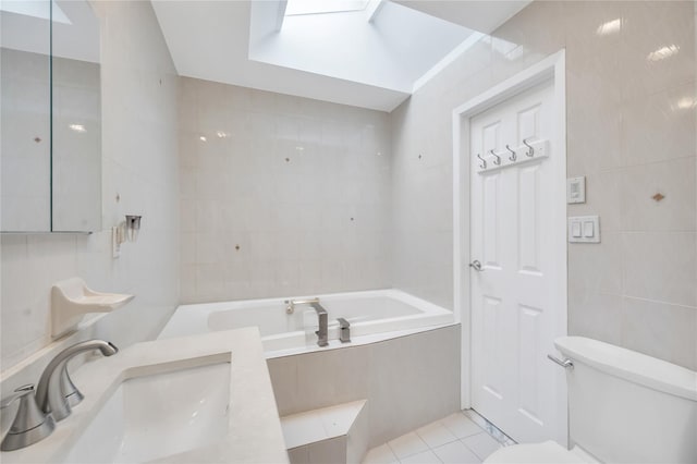bathroom with a sink, tile walls, tile patterned floors, toilet, and a bath
