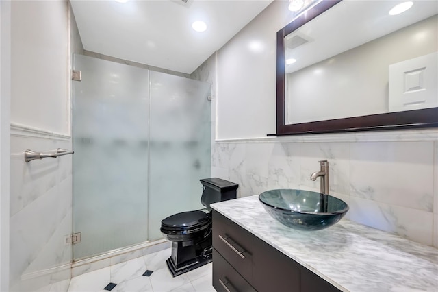 full bathroom with a shower stall, marble look tiles, vanity, tile walls, and toilet