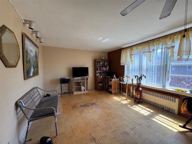 living room with wood finished floors and radiator
