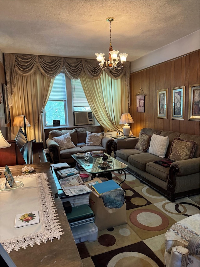 1171 Leland Ave, Bronx, NY 10472 - living room featuring a chandelier, wooden walls, a textured ceiling, and cooling unit