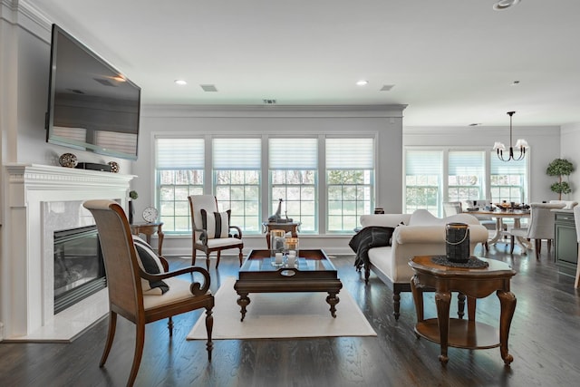 living room with visible vents, ornamental molding, a chandelier, and a wealth of natural light