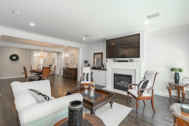 living room featuring crown molding, baseboards, dark wood-type flooring, and a glass covered fireplace