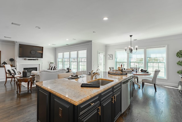 kitchen with a sink, dark cabinets, plenty of natural light, and dishwasher