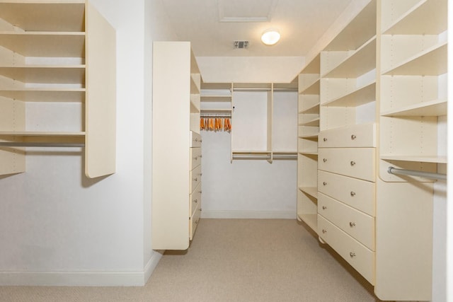walk in closet featuring visible vents and light carpet