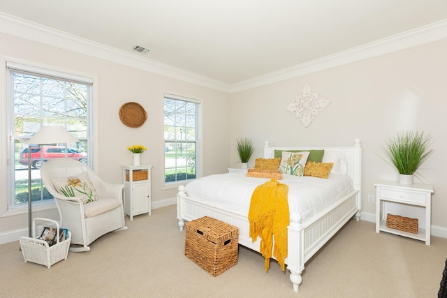 bedroom featuring crown molding, baseboards, and carpet