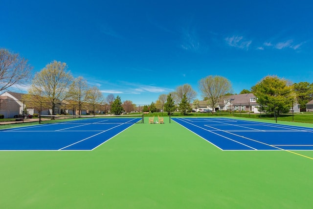 view of tennis court with fence and community basketball court