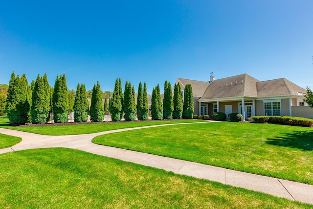 view of home's community with a lawn