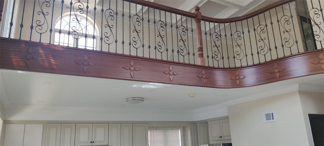 interior details with cream cabinets, ornamental molding, and visible vents