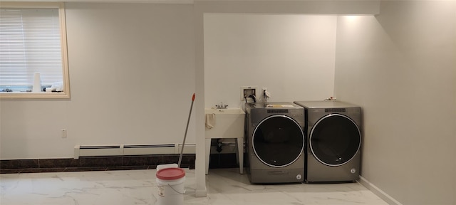 washroom featuring laundry area, independent washer and dryer, baseboard heating, baseboards, and marble finish floor