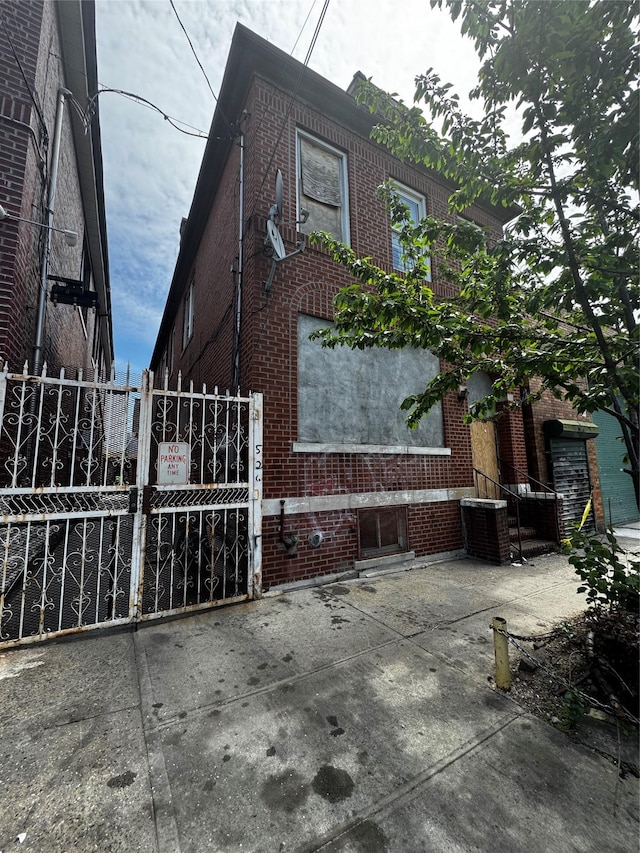 526 Barretto St, Bronx, NY 10474 - view of home's exterior featuring fence, a gate, cooling unit, and brick siding