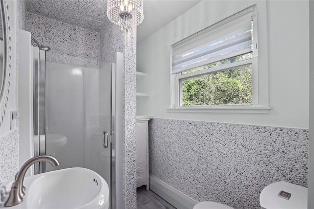 16 Nelson Ln, Garrison, NY 10524 - full bath with an inviting chandelier, a sink, toilet, wood finished floors, and a stall shower