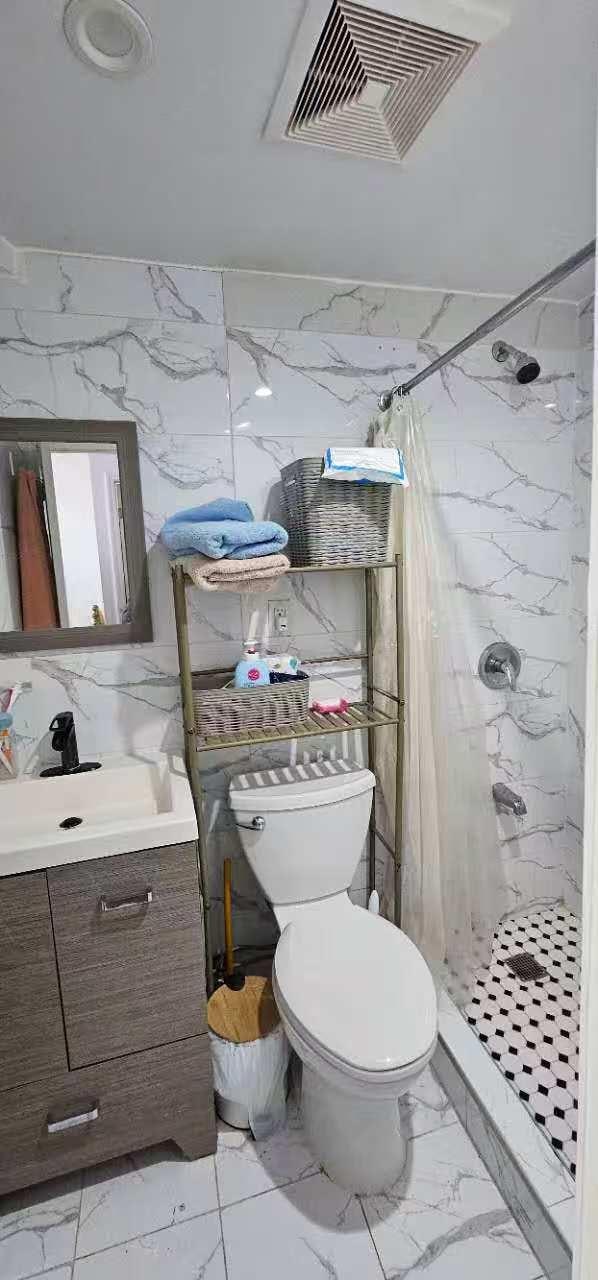 full bath featuring vanity, visible vents, a stall shower, and marble finish floor