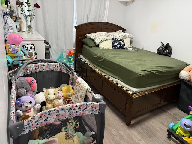 bedroom featuring light wood-style flooring