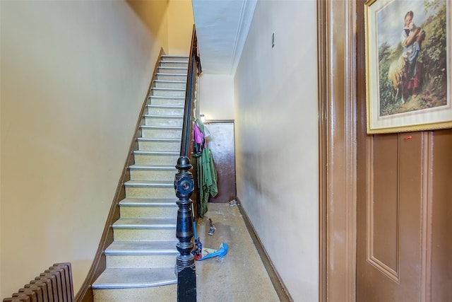 stairway featuring finished concrete floors and radiator