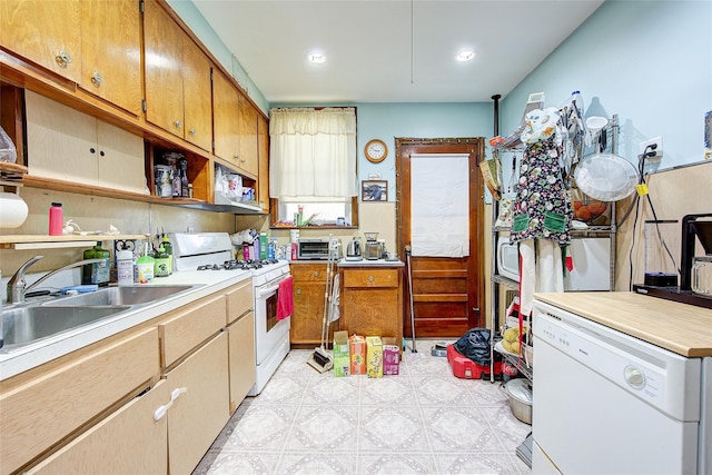 kitchen with open shelves, a sink, light countertops, light floors, and white appliances