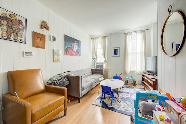 living room with light wood-style floors, radiator, and cooling unit