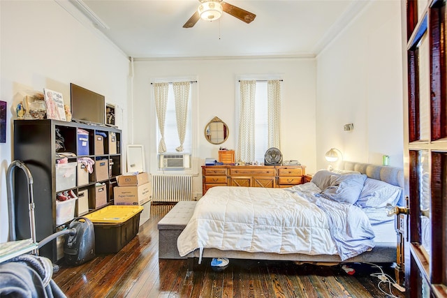 bedroom featuring ornamental molding, radiator, a ceiling fan, and hardwood / wood-style floors